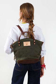 Model wearing olive colored back pack style bag with brown leather straps. Waxed Canvas Lunch Bag, Waxed Canvas Tote Bag, Wax Canvas, Lynchburg Virginia, Waxed Canvas Backpack, Waxed Canvas Bag, Crossbody Backpack, English Bridle, Free Tote