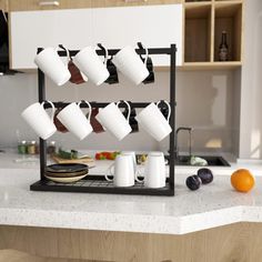 a kitchen counter with cups and plates on it