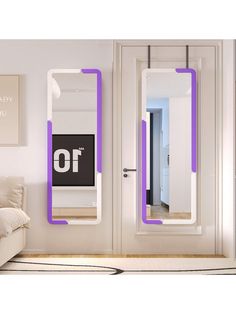 two mirrors are mounted to the wall in front of a couch and mirror with purple trim