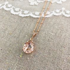 "Heatherly Designs solitaire pendant necklace made using a genuine Swarovski® crystal in blush pink which dangles from a decorated bail with tiny pave cubic zirconia. ●Perfect matching earrings: https://www.etsy.com/listing/472354187 ●Nickel free ●Length (adjustable): 17\" - 19\" or 43.18 - 48.26cm ●Pendant Size: 14x10mm ●Swarovski® crystal color name(s): Vintage Rose ●Arrives in our signature Heatherly gift box. Handmade with ❤️ by Heather ● ● ● ● ● ● ● ● ● ● ● ● ● ● ● ● ● ● ● ● ● ● ● ● ● ● ● ● Elegant Rose Gold Crystal Necklace For Wedding, Elegant Pink Crystal Necklaces For Weddings, Elegant Blush Necklace For Gift, Pink Crystal Necklaces For Wedding, Elegant Pink Teardrop Pendant Drop Necklace, Elegant Pink Teardrop Crystal Necklaces, Elegant Pink Teardrop Crystal Necklace, Crystal Necklace Rose, Pink Crystal Necklace