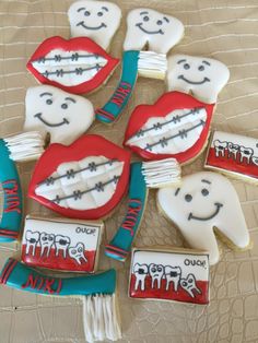 decorated cookies are arranged in the shape of toothbrushes with teeth and mouthpaste on them