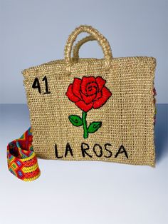 a jute bag with a rose embroidered on the front and number one in spanish