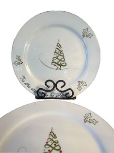 two plates with christmas designs on them are stacked up in front of each other,