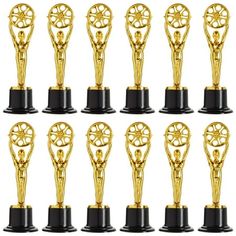 twelve golden trophy trophies with black bases and gold decorations on each one's pedestal