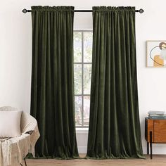 a green curtain hanging in front of a window