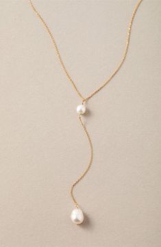 Two glowing freshwater pearls delicately station the top and bottom of this handmade Y-necklace that brings low-key elegance to any look. 16" length; 4" pendant drop Pearl size: 7–8mm 14k-gold fill/freshwater potato pearl Imported Dainty Gold Necklace With Pearl, Delicate Pearl Drop Lariat Necklace, Delicate Lariat Drop Necklace With Pearl, Dainty Adjustable Lariat Necklace With Pearl Pendant, Minimalist Pearl Lariat Necklace, Dainty Pearl Charm Lariat Necklace, Delicate Adjustable Lariat Necklace With Pearl Drop, Minimalist Pearl Lariat Drop Necklace, Delicate Adjustable Pearl Drop Necklace