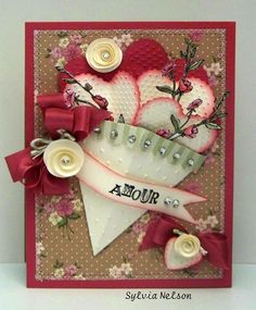 a handmade card with flowers and hearts on the front, which says aour