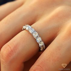 a woman's hand with a diamond ring on it