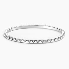 a white gold bang bracelet with pyramids on the sides and an open clasp at the end