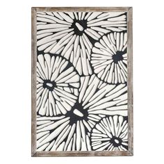 an art piece with white and black flowers on it