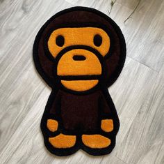 a brown and black monkey rug sitting on top of a wooden floor next to a plant