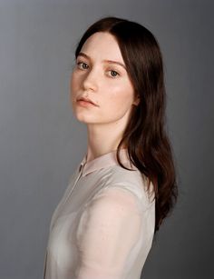 a woman in a white shirt posing for a photo