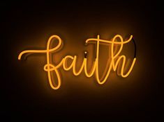 a neon sign that says faith