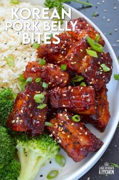 korean pork belly bites with broccoli and rice on a white plate topped with sesame seeds