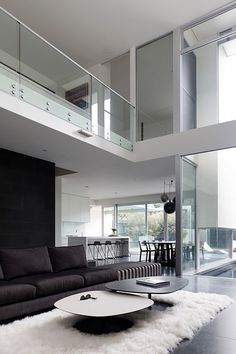 a living room filled with furniture and lots of windows