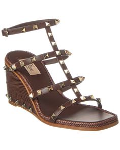 About The Brand: Signature Elegance With A Modern Aesthetic. Please Note: Size Selections Are European. For Us Conversions, Please Reference Size Chart. Based On Feedback From Members, This Brand Typically Runs Small. We Suggest Sizing Up A Half Size For Most Styles. Made In Spain Rockstud Caged 90 Leather Ankle Strap Wedge Sandal In Brown Leather With Platinum-Finish Rockstuds Adjustable Ankle Strap With Buckle Closure Lightly Padded Leather Insole Smooth Leather Sole 3.5In Heel Please Note: All Measurements Are Approximate And Were Taken From A Size 37; Slight Variations May Occur. Our Products Are 100% Genuine. In Some Cases We Purchase Merchandise From Trusted Independent Suppliers And Not Directly From The Brand Owner. In All Cases We Stand By The ity Of Every Product Sold On Our Site Brand Owner, Ankle Strap Wedges, Strap Wedge, Valentino Rockstud, Dior Shoes, Modern Aesthetic, Wedge Sandal, Chanel Handbags, Smooth Leather