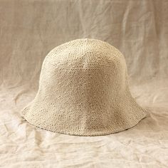 a white hat sitting on top of a bed