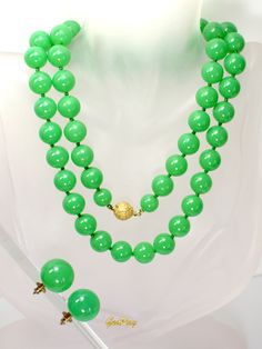 "This is an original Art Deco 1930s vintage green faux Jade Celuloid / Early Plastic  jewelry set: beaded necklace and clip-on earrings. The necklace measures almost 29\" long, it weighs 1.4 oz and the beads are 3/8\" in diameter.  The earrings are 3/4 in diameter and the weight of one earring is 0.1 oz.  It is a vintage item in excellent condition. We combine shipping,  Thank You for visiting our Etsy https://www.etsy.com/shop/VictoryIssweet store!" Vintage Jade Necklace For Formal Occasions, Green Single Strand Jewelry For Party, Single Strand Green Jewelry For Party, Formal Green Beaded Necklace, Vintage Jade Beaded Necklaces, Vintage Jade Jewelry With Round Beads, Classic Green Beaded Necklaces With Round Beads, Formal Green Single Strand Beaded Necklace, Vintage Single Strand Jade Jewelry