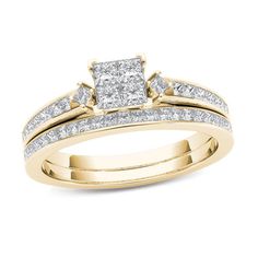 a yellow gold wedding ring set with two princess cut diamonds on the shoulders and sides