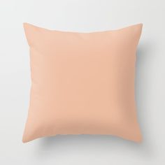 a peach colored pillow on a white wall