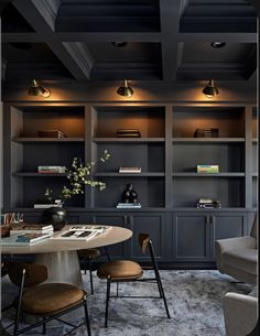 a living room filled with furniture and bookshelves next to a dining room table