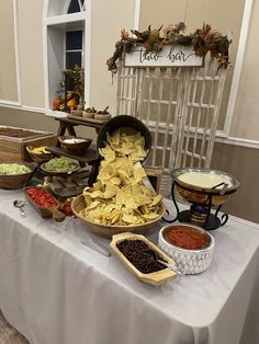 a buffet table filled with different types of food and condiments on top of it