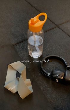 a pair of scissors sitting next to a water bottle