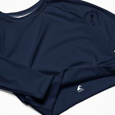 This classic navy blue long-sleeve crop top from Extremely Stoked is made of a smooth, good feeling, recycled polyester and elastane, making it an eco-friendly choice for swimming, sports, or athleisure outfits. The crop top has a tear-away care label and a wide, double-layered waistline band for a super comfy fit. • UPF 50+ • Trendy, cropped fit • Wide, double-layered waistline band • Raglan sleeves • Tear-away care label • Size up if you’re between sizes as this fabric can be tight on the body Blue Long Sleeve Crop Top, Surf Stickers, Athletic Shorts Women, Athletic Swim, Athletic Swimwear, Navy Blue Long Sleeve, Good Feeling, Flared Leggings, Womens Windbreaker