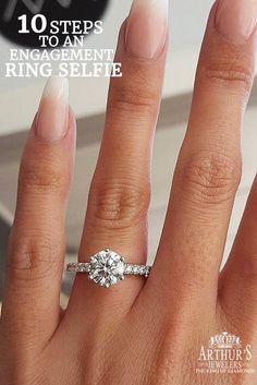 a woman's hand with a ring on it and a diamond in the middle