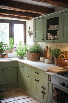 a kitchen filled with lots of green cupboards