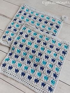 two crocheted placemats sitting on top of a wooden floor next to each other