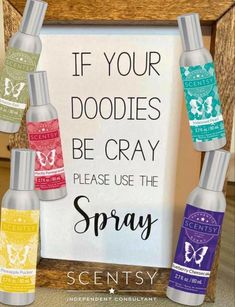 three bottles of spray in front of a sign with the words if your doodles be cray please use the spray