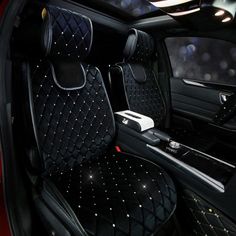 the inside of a car with black leather seats and diamond trimmings on it