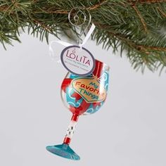 a glass ornament hanging from a christmas tree with a candy bar on it