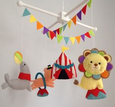 three stuffed animals hanging from a mobile in a child's playroom or nursery