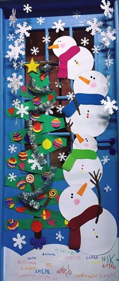 the door is decorated with snowmen and christmas trees, which are all made out of cardboard