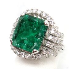 TOTAL RING WEIGHS 13.2 GRAMS 18K & 11. ct NATURAL COLOMBIAN EMERALD (EXCELLENT COLOR WITH NATURAL INCLUSION'S) & (42) 2pt SINGLE CUT GEMS WHITE DIAMONDS AND (12) 6pt BRILLIANT CUT ROUND GEM WHITE CLEAN DIAMONDS  /  SIZE 7 1/2  Contact our office for any questions you may have  We are available Monday - Friday 10am-5pm EST All emails sent over the weekend will be answered on Monday We deal with preowned, vintage, estate items and collectables. The word excellent is used only to describe the condi Gia Certified Emerald Cut Collectible Jewelry, Golden Rings, Golden Ring, Wedding Accessories Jewelry, Chic Leather, Colombian Emeralds, Emerald Cut Diamonds, Natural Emerald, Diamond Sizes