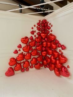 red hearts are arranged in the shape of a christmas tree