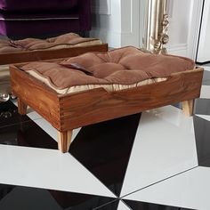 two wooden beds sitting on top of a black and white checkered floor next to each other