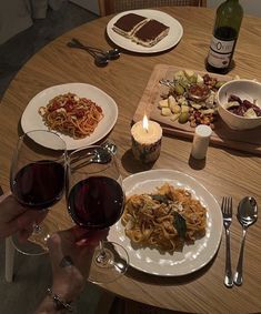 a table topped with plates of food and glasses of wine