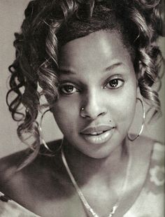 a black and white photo of a woman with curly hair