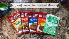 five bags of freezer to crockpot meals sitting on a granite counter top