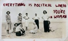 a group of women standing next to each other on a beach