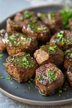 Grilled steak bites garnished with chopped parsley on a grey plate. Steak Bites With Garlic Butter, Tender Steak Bites, Garlic Butter Recipe, Prime Rib Steak, Gourmet Steak, Garlic Knots Recipe