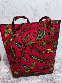 These handmade  Ankara tote bags are great to give as gifts or pop into your handbag  collection for when you go for shopping.  Ankara is 100% wax cotton. The bags are approximately 12.5 by 6 by 16.5( top width ) and 10.5( bottom width Ankara School Bag, Red Ankara Fabric With Traditional Patterns, Red Ankara Fabric, Ankara Tote Bag, Structured Tote Bag, Ankara Fabric With Vibrant Patterned Print, Handbag Collection, Waxed Cotton, Dark Red