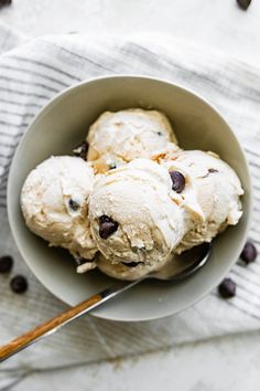 three scoops of ice cream in a bowl with chocolate chips