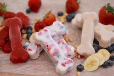 some dog treats are on a table with strawberries and bananas