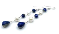 A pair of long earrings crafted with 925 sterling silver, blue lapis lazuli and freshwater white pearls. LENGTH:  3.3 inches - 8,3 cm - 6,5 gr. Drops : 13 x 11 mm MATERIALS: 925 Sterling Silver Lapis Lazuli Freshwater Pearls All jewellery is shipped in a working day with registered mail. If you require quick delivery, please consider our Express Shipping option. Free pouch drawstring bag with every order Sofia's Bijoux jewelry: http://www.etsy.com/it/shop/Sofiasbijoux More Earrings: https://www. Elegant Lapis Lazuli Earrings With Natural Stones, Silver Sterling Silver Pearl Earrings With Natural Stones, Silver Pearl Earrings With Natural Stones In Sterling Silver, Sterling Silver Blue Jewelry With Pearl Drop, Sterling Silver Dangle Pearl Earrings With Natural Stones, Elegant Sterling Silver Pearl Earrings With Natural Stones, Elegant Blue Sterling Silver Linear Earrings, Blue Sterling Silver Pearl Earrings As Gift, Elegant Lapis Lazuli Dangle Jewelry