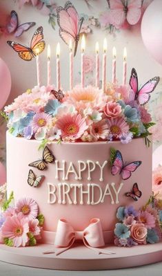 a pink birthday cake with butterflies and flowers on it