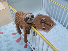 a stuffed slotty in a crib next to a baby's teddy bear